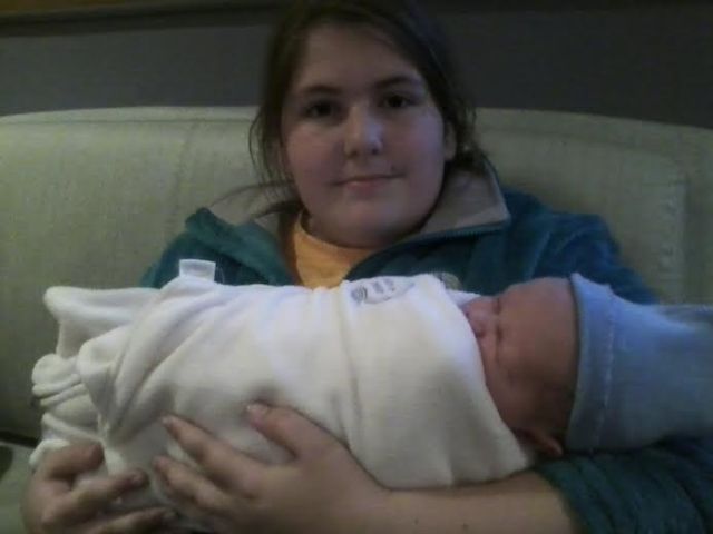 Colleen holds her new baby cousin, just a few hours old.